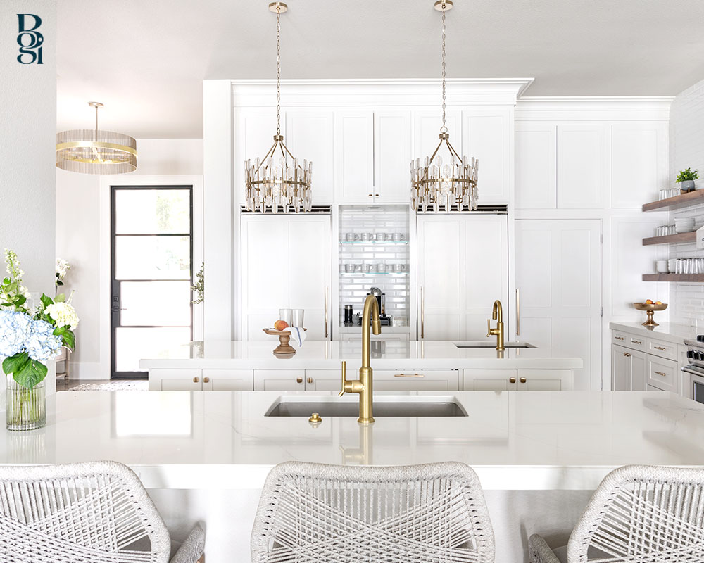 remodeled kitchen in trending white cupboards and natural wood shelves and gold accented lighting