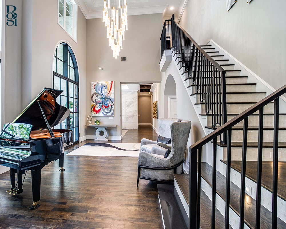 beautiful winding staircase with an open wood floor and a baby grand piano