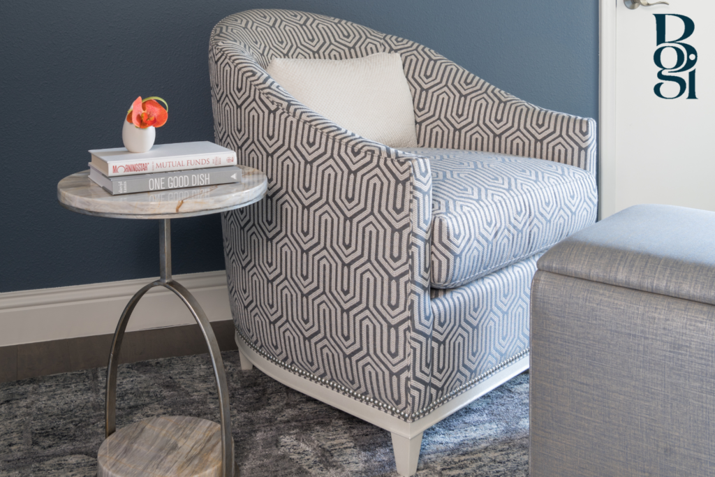 corner chair in a matte blue room chosen by BGI Designs
