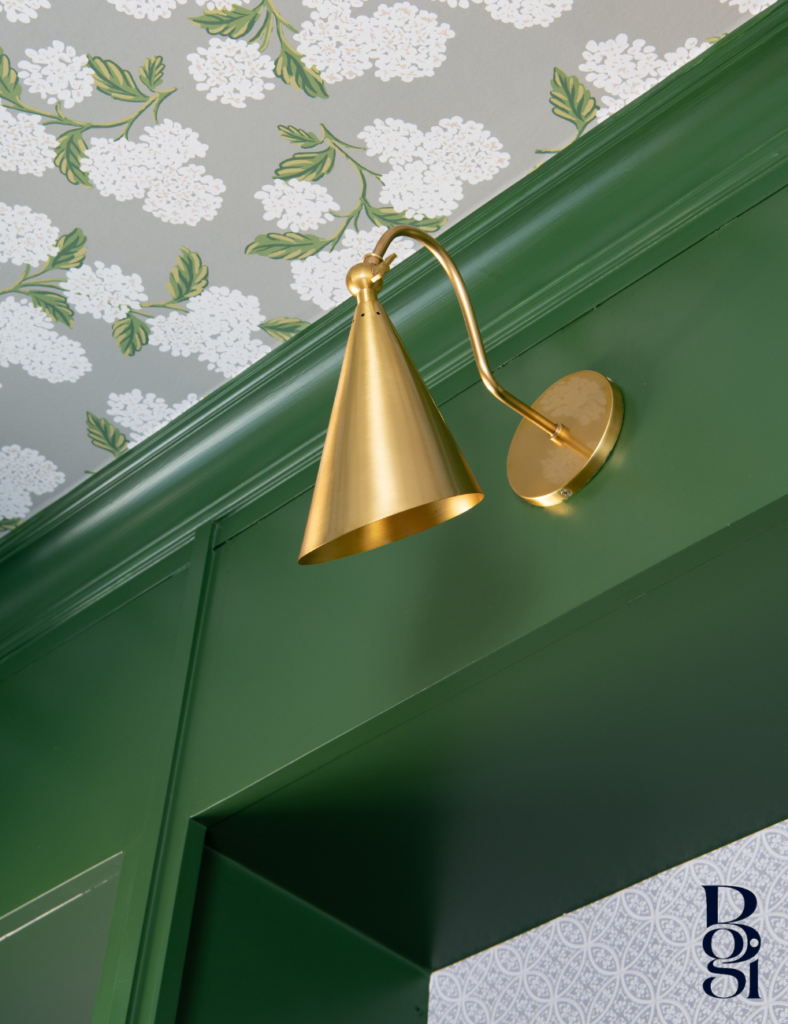showcasing a gorgeous gold light deep and vibrant green cabinet and white flowers on gray wallpapered ceiling