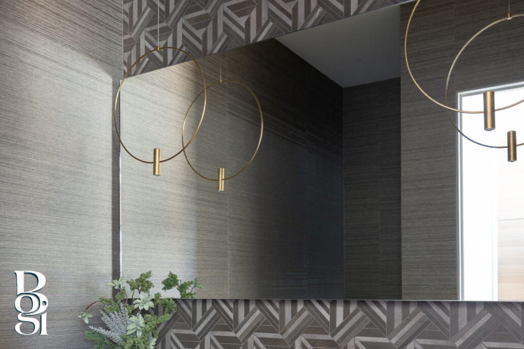 gray geometrical wallpaper in the bathroom with gorgeous gold simple circular lighting